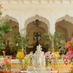 Charming floral arrangements in a historic palace courtyard creating a serene ambiance.