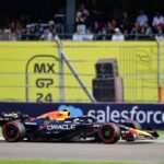 Dynamic shot of an F1 car racing at Mexico City Grand Prix with a cheering crowd in the background.