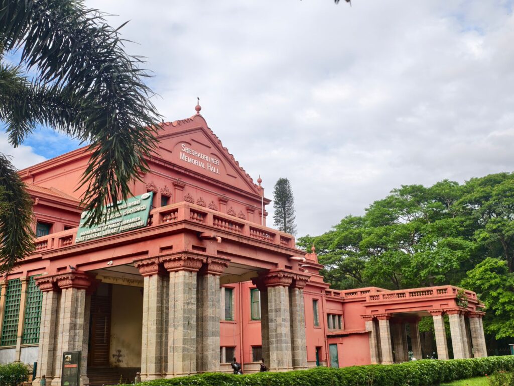 Historic Sheshadri Iyer Memorial Hall amidst lush greenery in Bangalore, India.