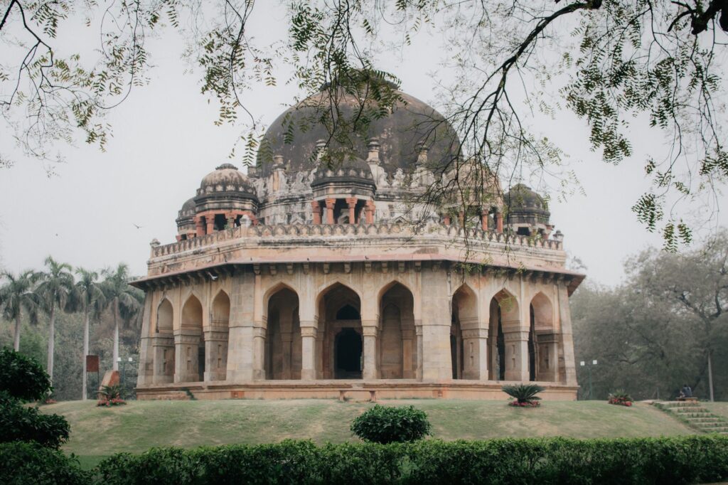 Historic tomb of Sikandar Lodi surrounded by lush greenery in New Delhi, India.