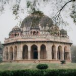 Historic tomb of Sikandar Lodi surrounded by lush greenery in New Delhi, India.