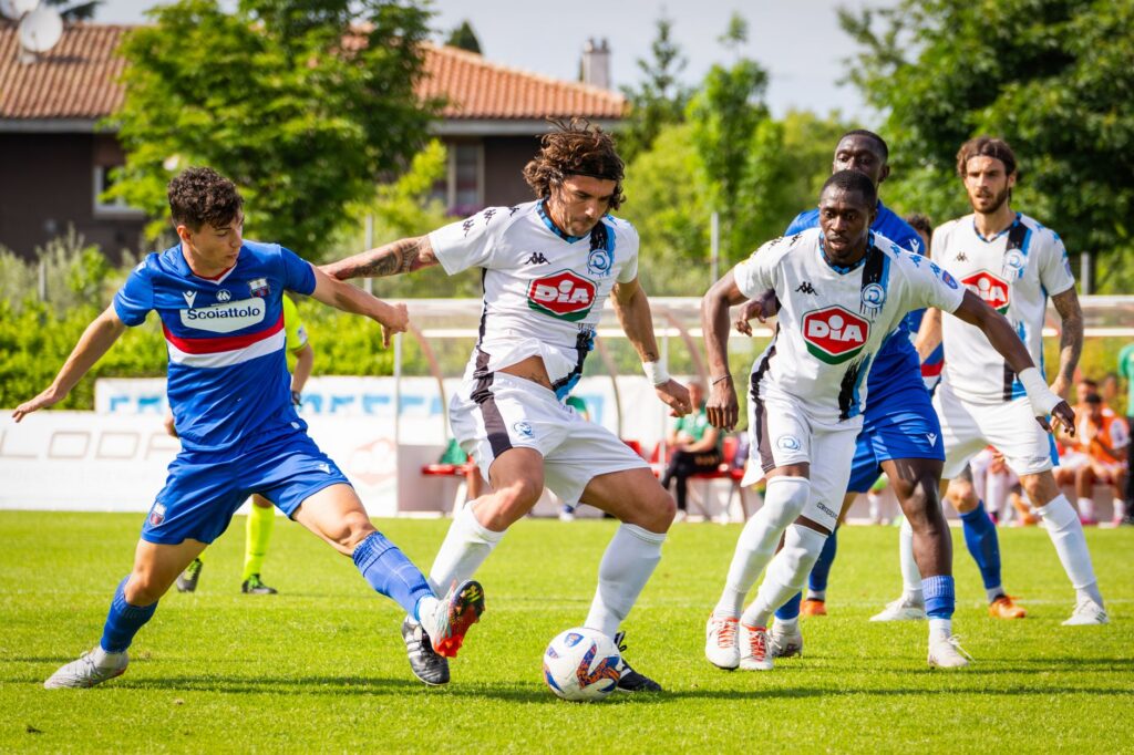 Exciting soccer match with players in action on a sunny field. Intense competition and athleticism displayed.