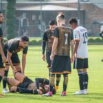 Players gather around an injured teammate during a soccer match in Texcoco, Mexico.