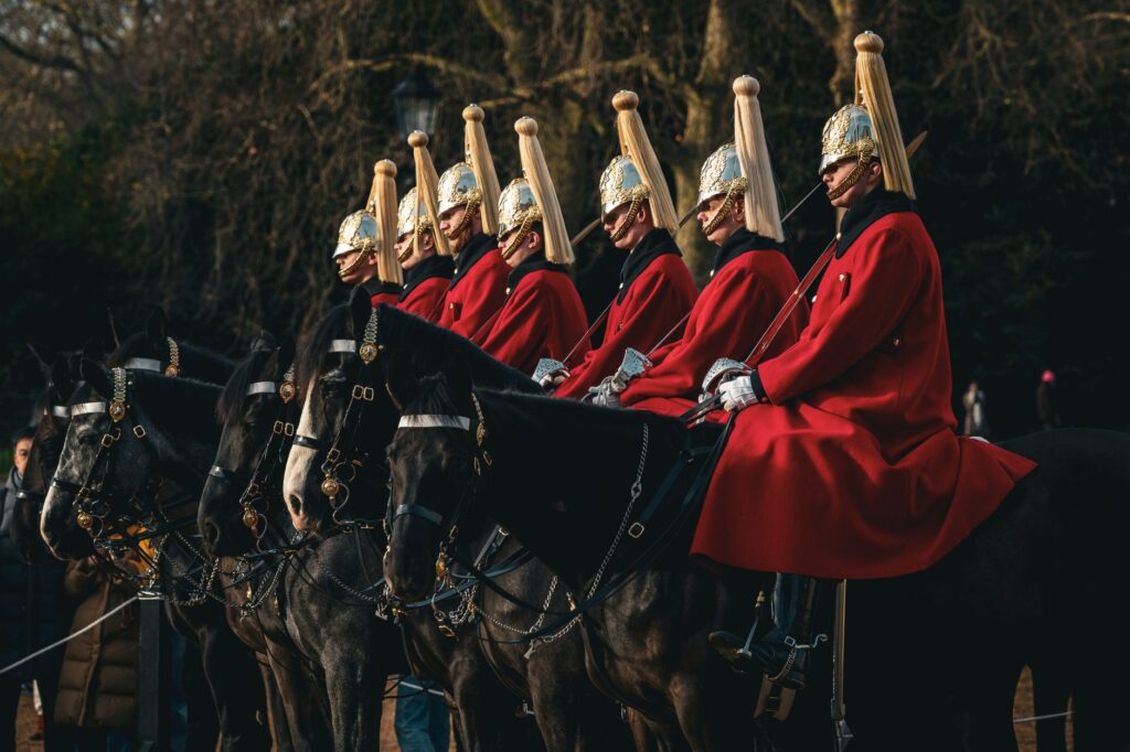Ceremonial horse guard parade in London, England showcasing traditional British uniforms and horses.