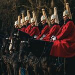 Ceremonial horse guard parade in London, England showcasing traditional British uniforms and horses.