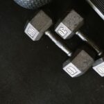 Close-up of black dumbbells on a gym floor, perfect for fitness themes.