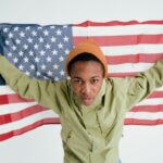 Teen boy holding the American flag, symbolizing patriotism and freedom.
