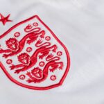 Detailed look at the England national football team's emblem on a jersey.
