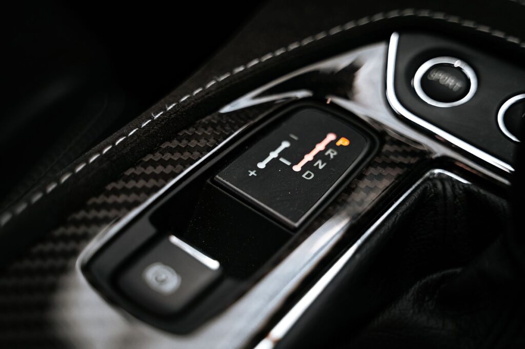 Detailed close-up of a modern car's gear shift indicator showcasing technology and design.