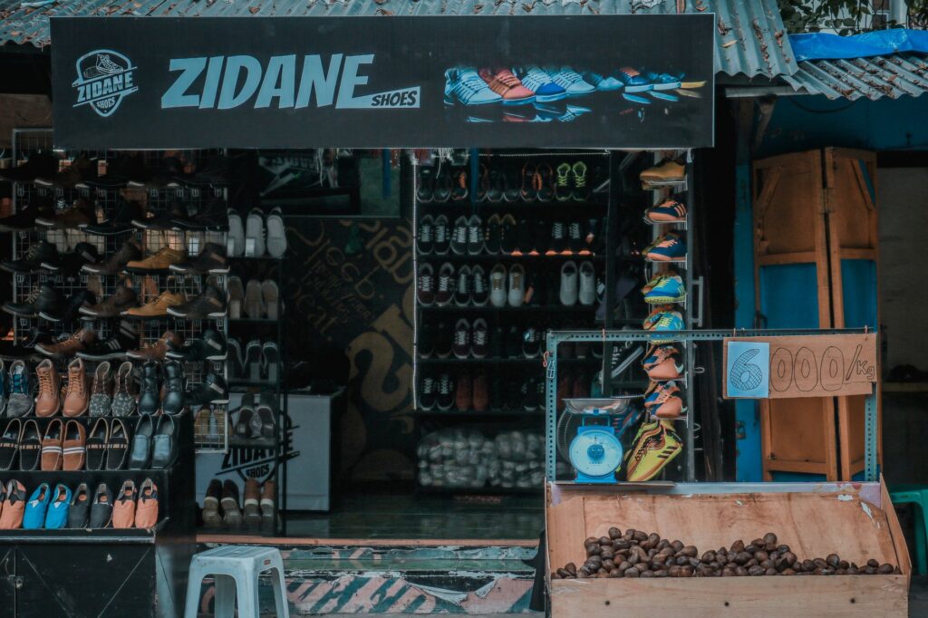 A vibrant shoe store showcasing various footwear in an urban market setting.